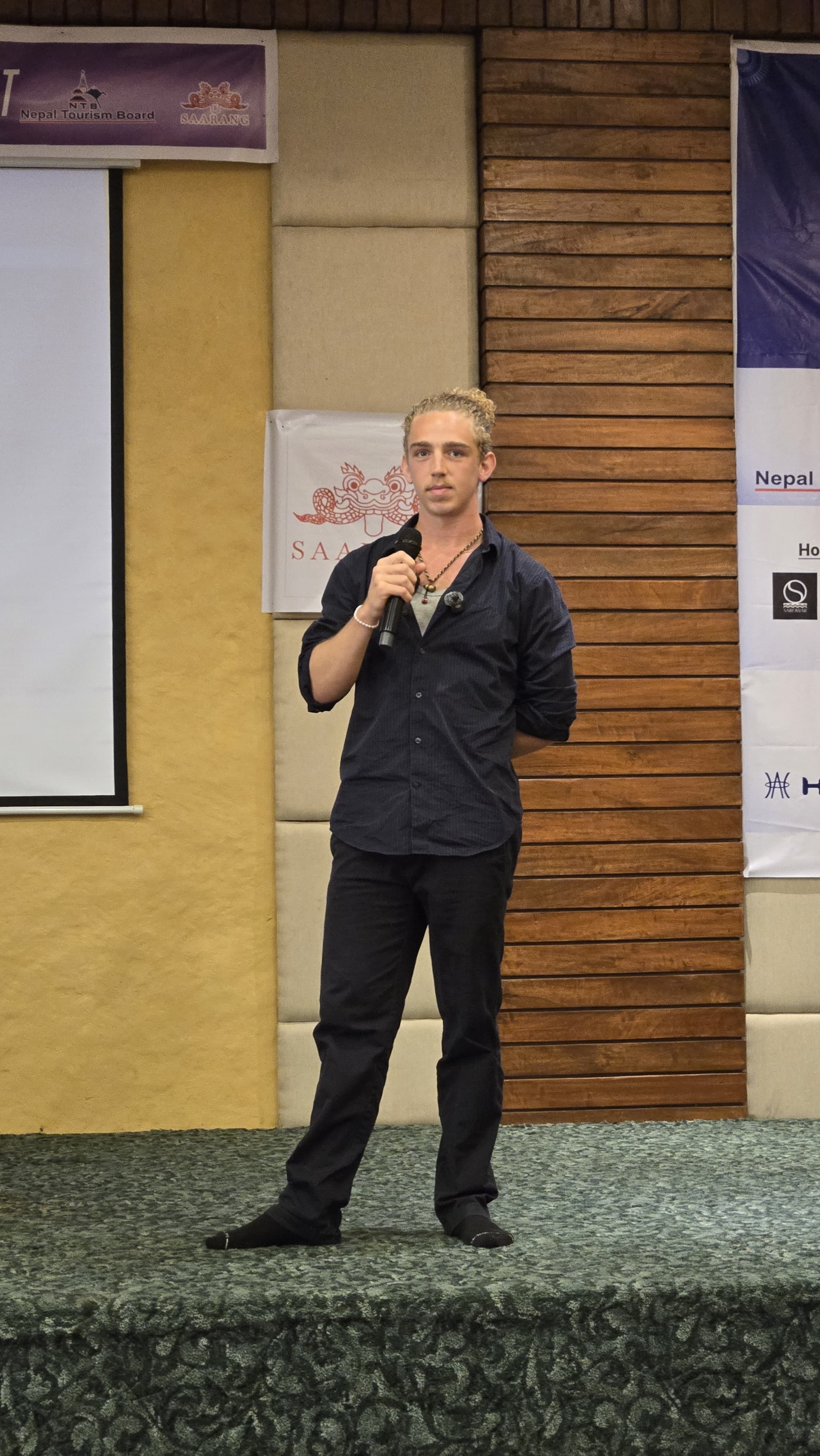 Sam Gute Rogers speaking on stage
